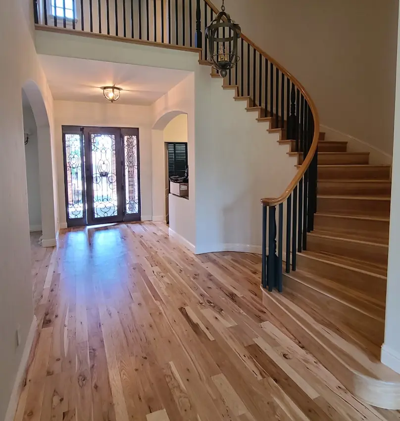 Hickory hardwood floor entryway and grand staircase